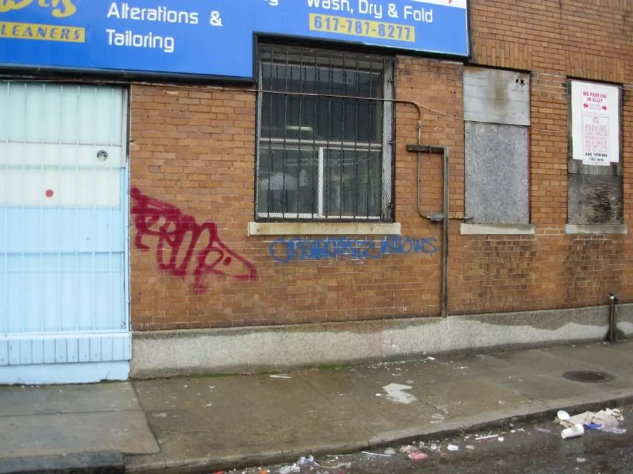 The picture is taken outside the street. At the bottom there is footpath and road, on the road...