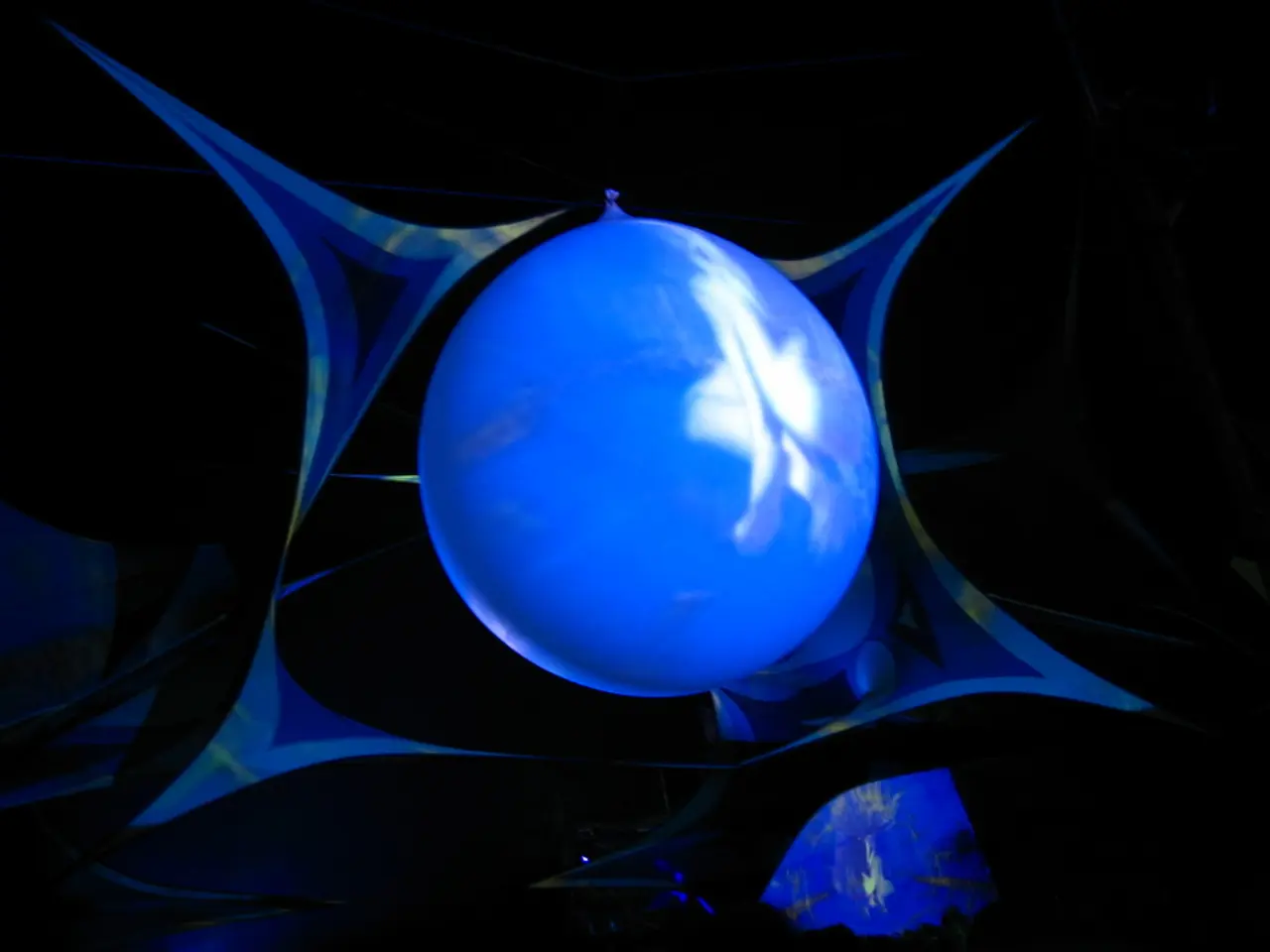 In this picture we can see a blue color balloon in the middle of the image.