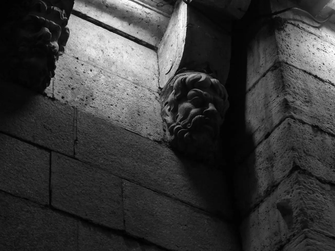 In this image I can see sculptures and a cement wall. This image is taken may be in a building.