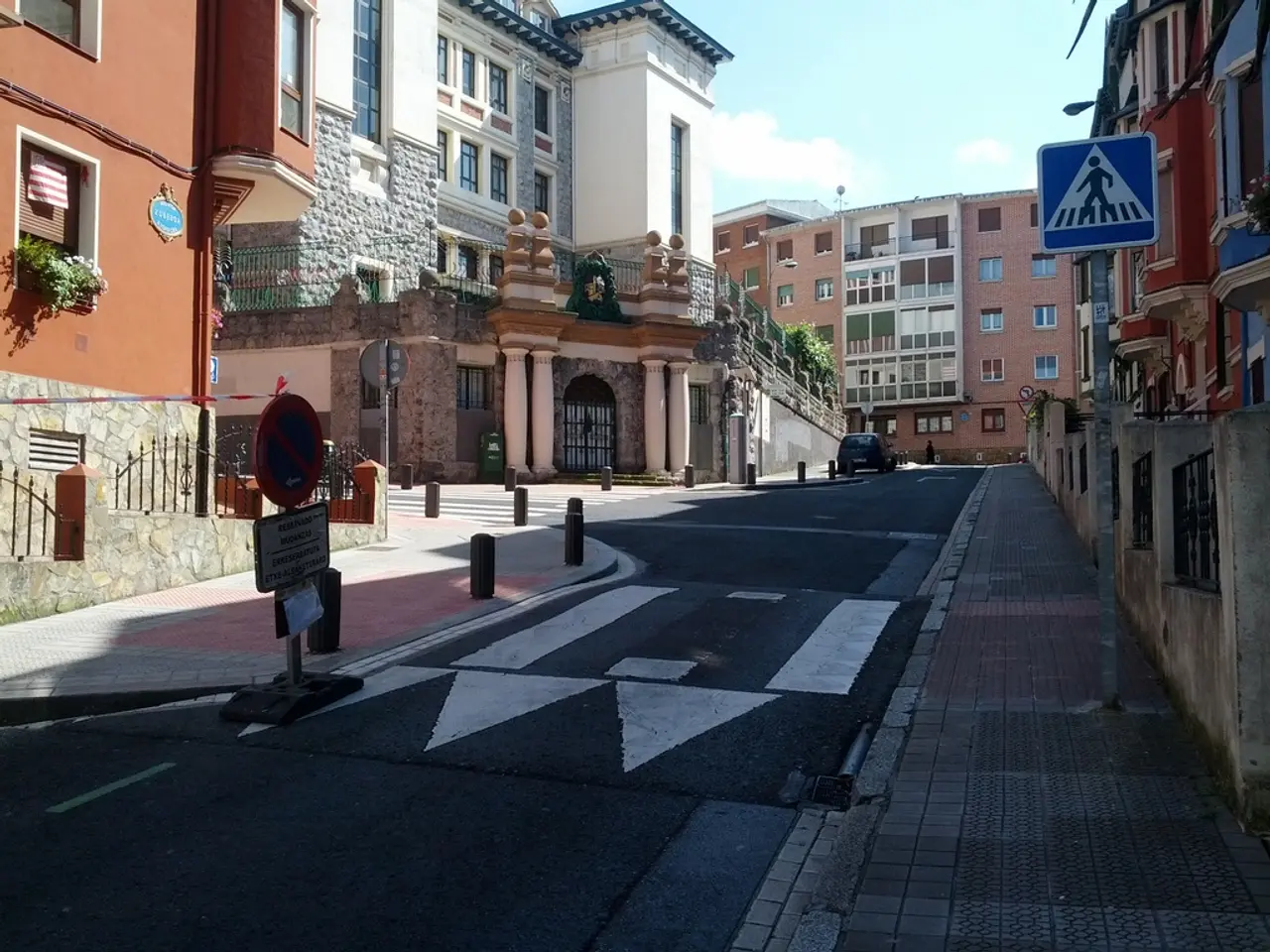 Vehicle is on the road. These are sign boards. Buildings with windows and plants. These are...