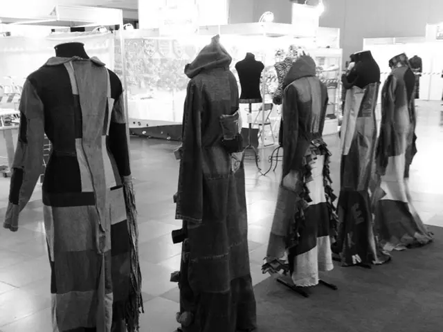 In this black and white picture there are mannequins. There are dressed to the mannequins. There is...